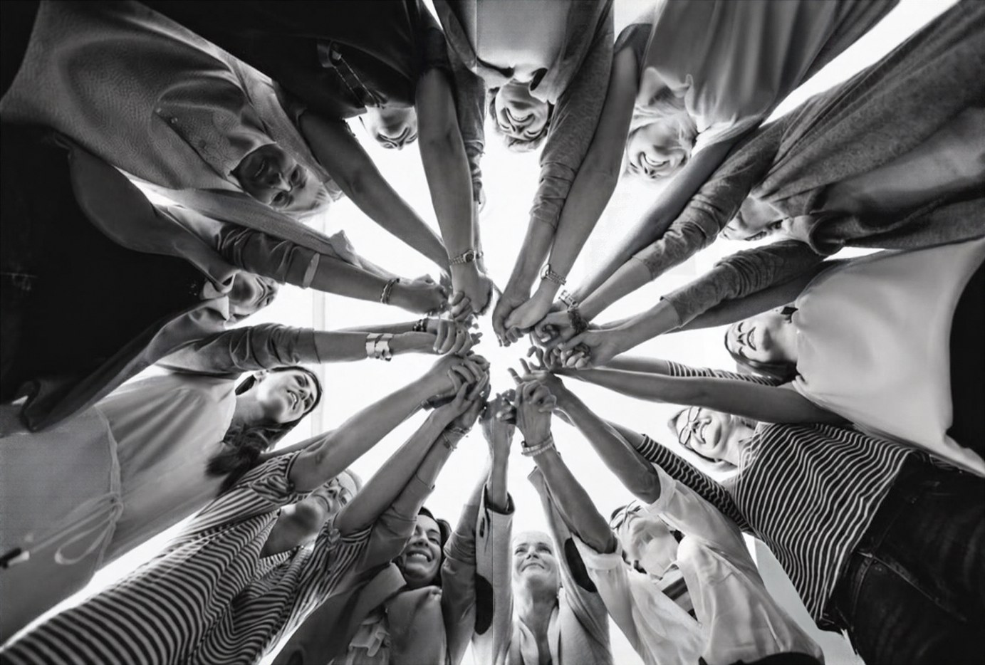 A group of women joining hands in a circle